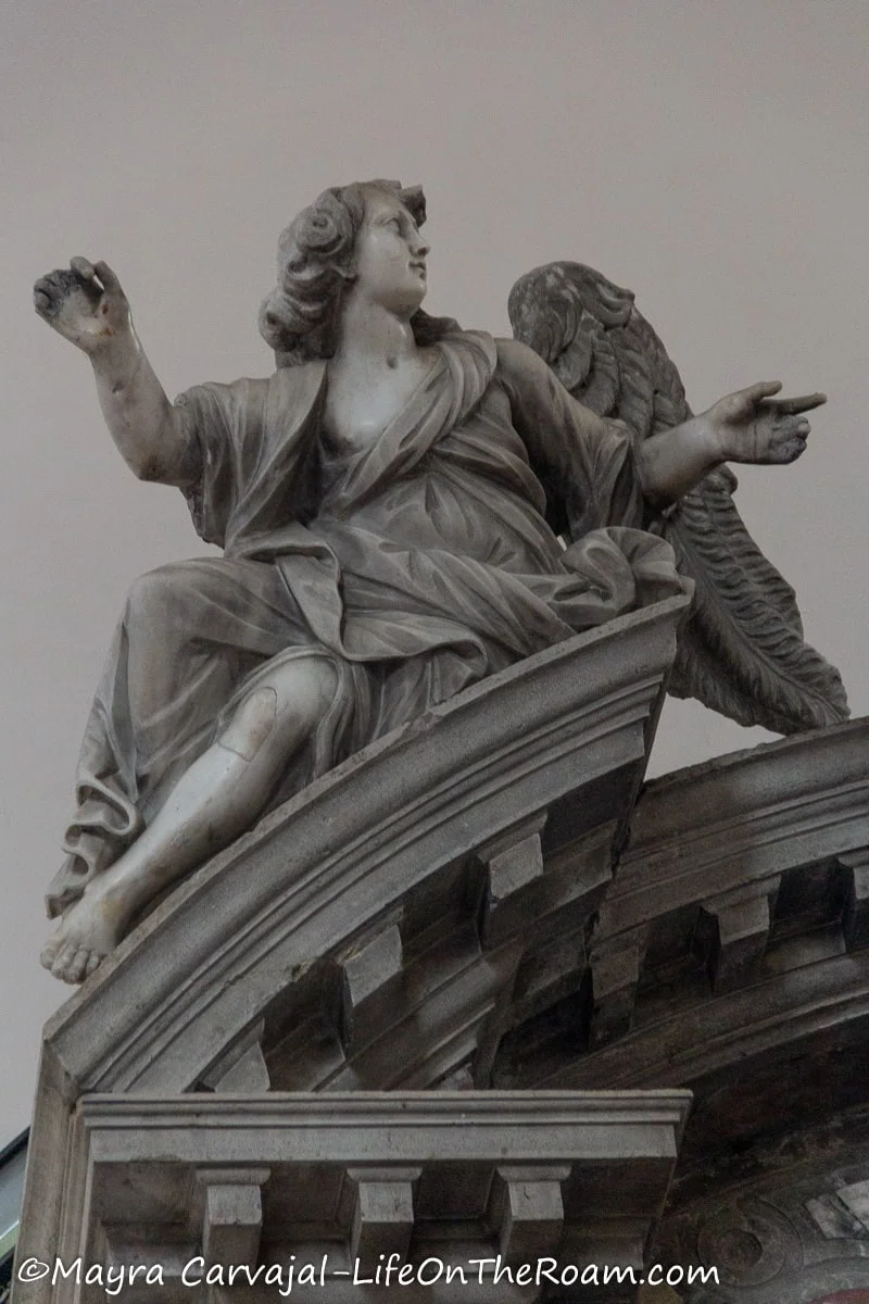 A small statue of a sitting angel 