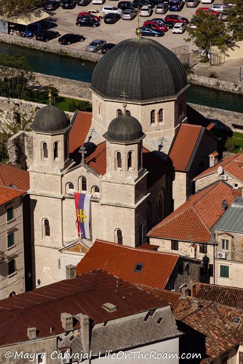 View from above of a church with a big central dome and two smaller domes at the top of towers