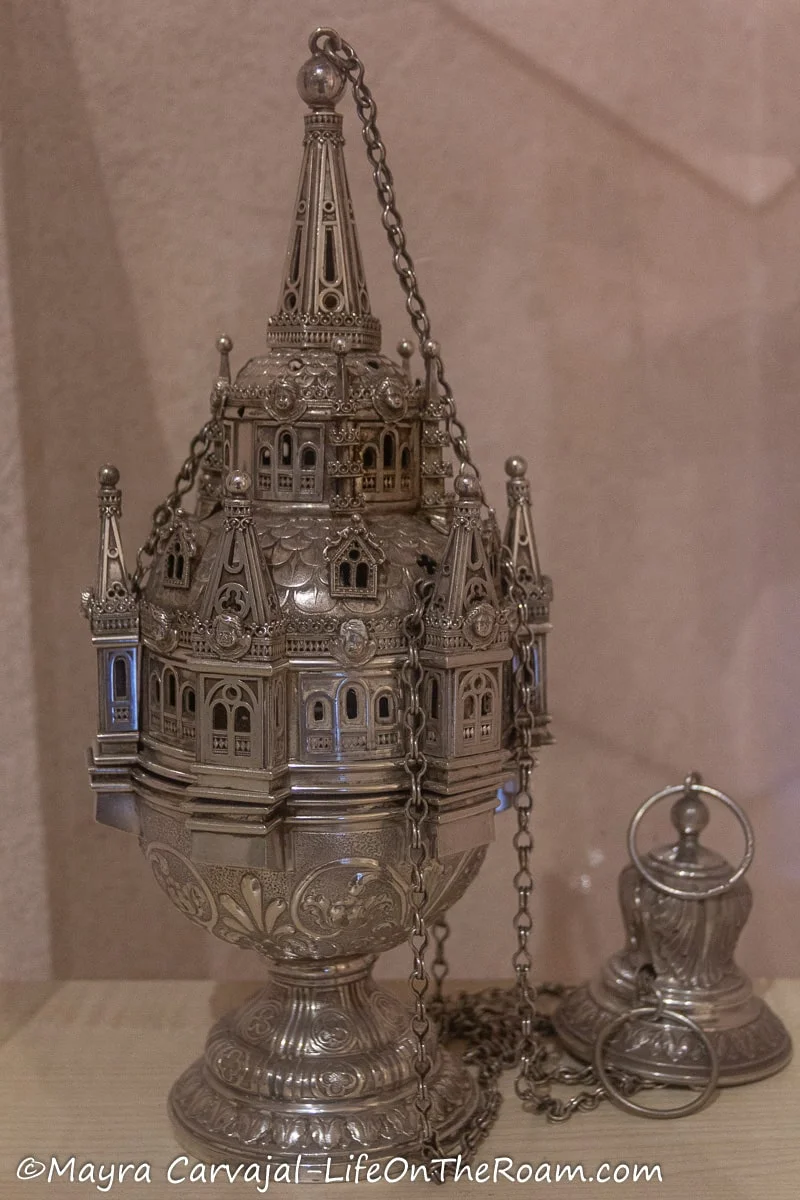 An incense burner in silver in the shape of a church