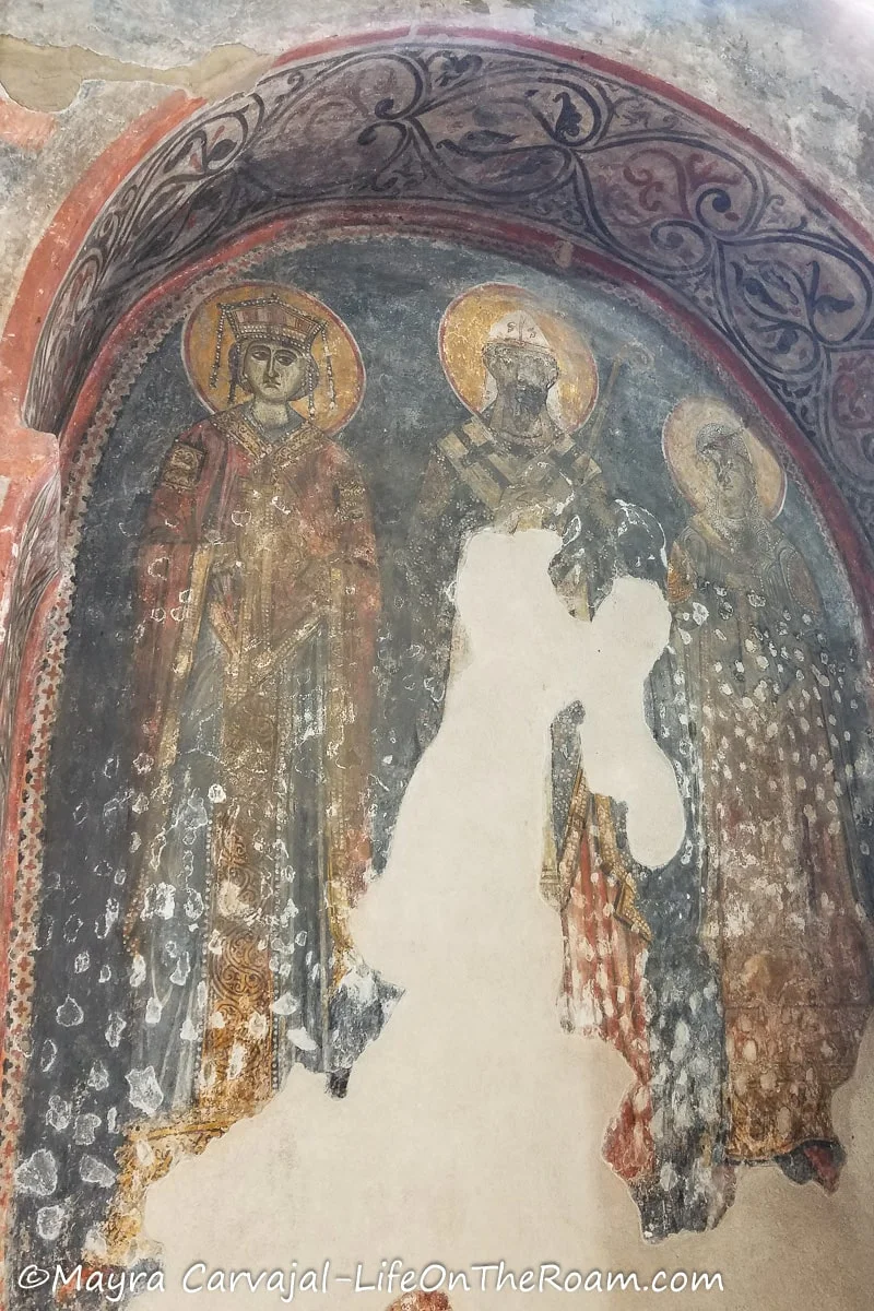 An old fresco depicting three saints