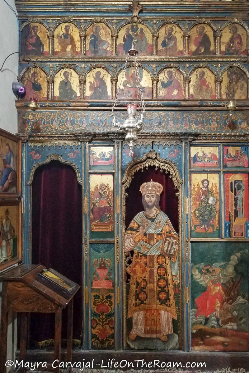 An old iconostasis with paintings of saints in Russian Orthodox style in bright colours
