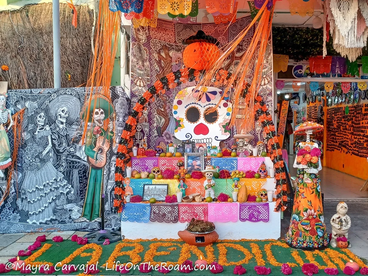 An multilevel altar featuring common items for the Day of the Dead celebration in Mexico: arches with flowers, depicting of colourful skeleton and perforated paper