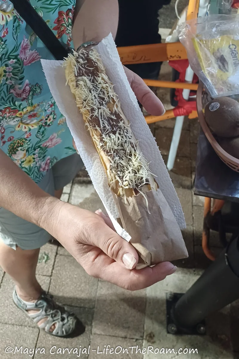 Mayra holding a rolled wafer with toppings