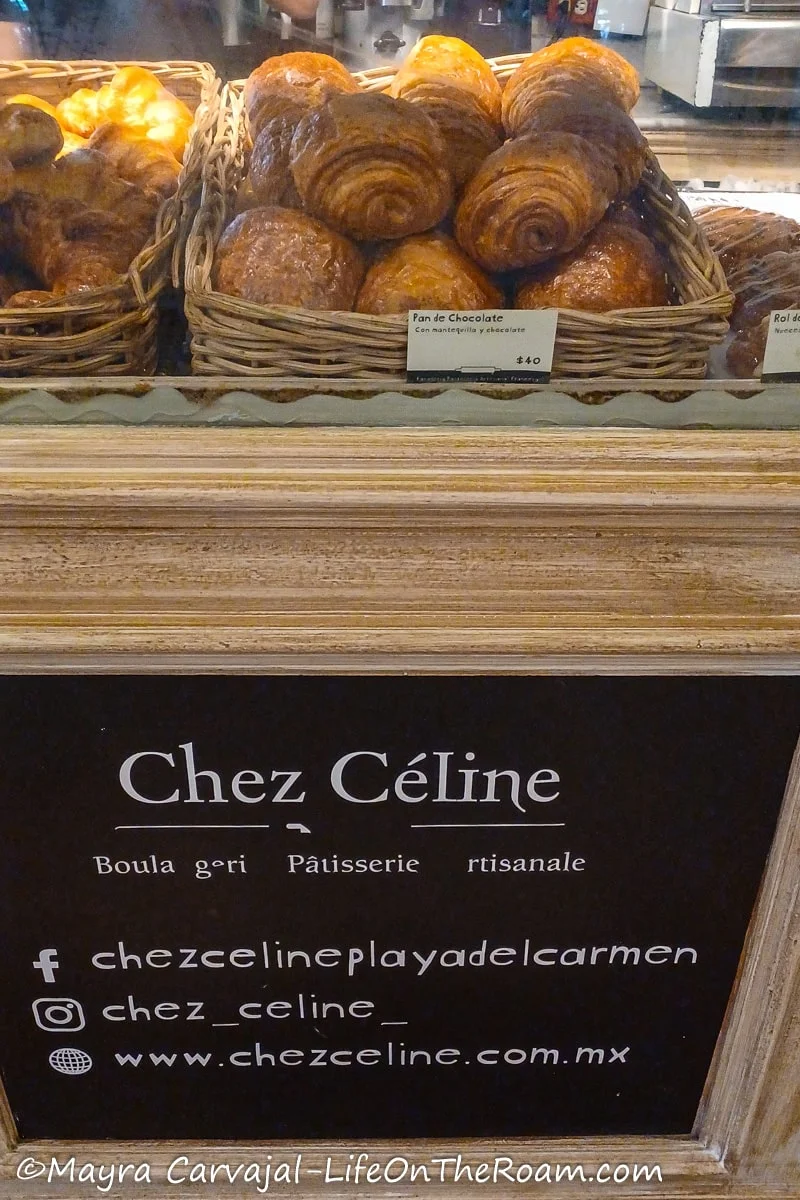 Trays of croissant on a display and the sign "Chez Celine" under