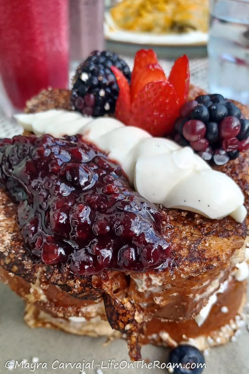 Berry compote and fruit on top of a French Toast
