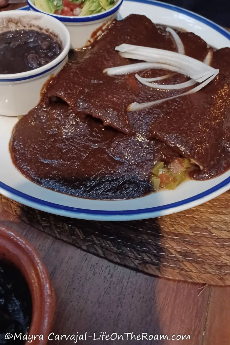Enchiladas covered with a brown sauce