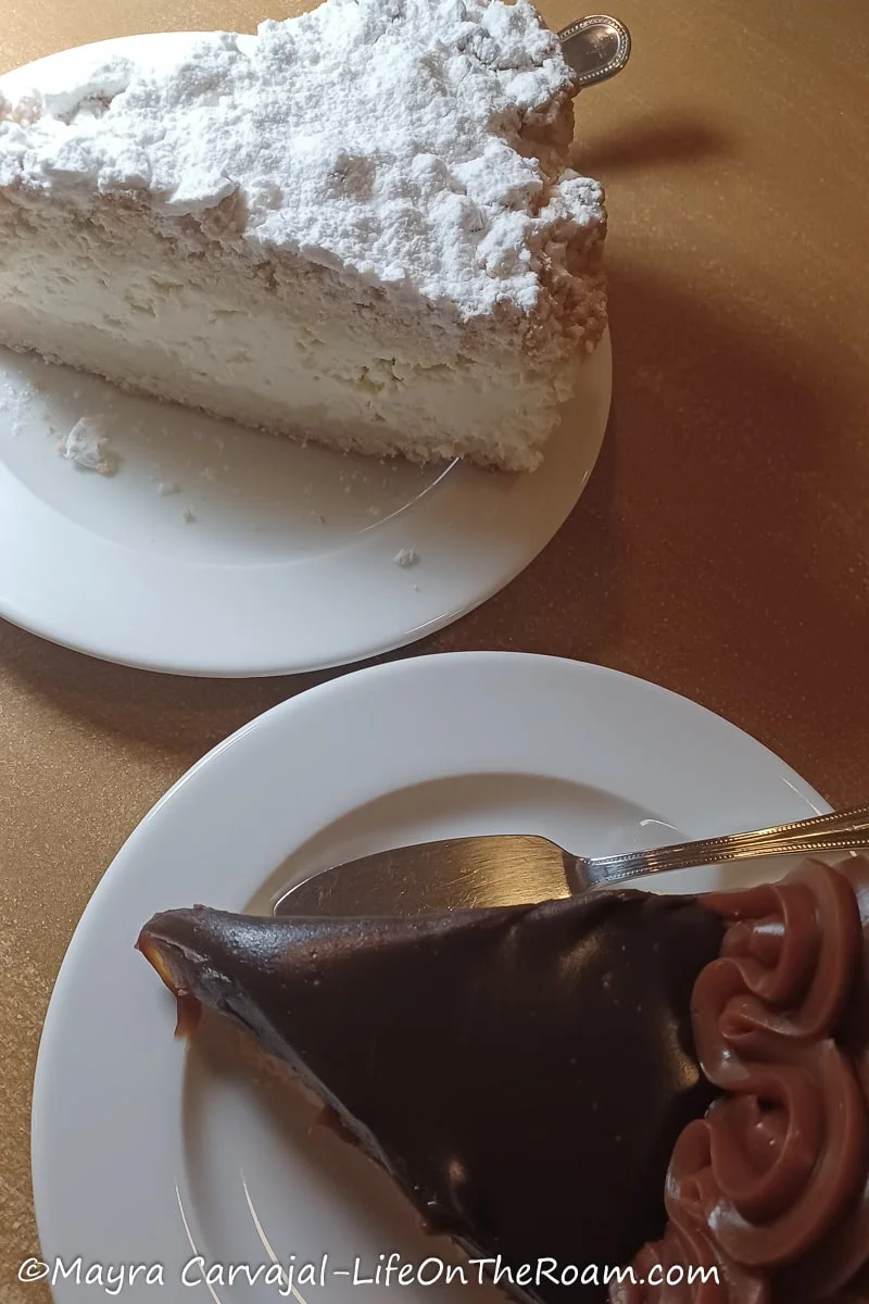 Two slices of cake on two plates on a table