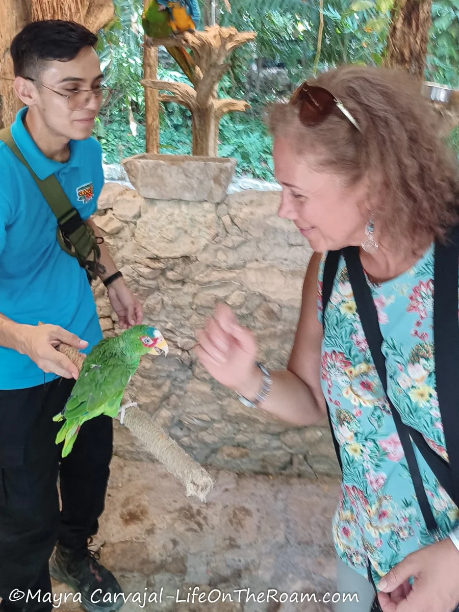 Mayra feeding a parrot