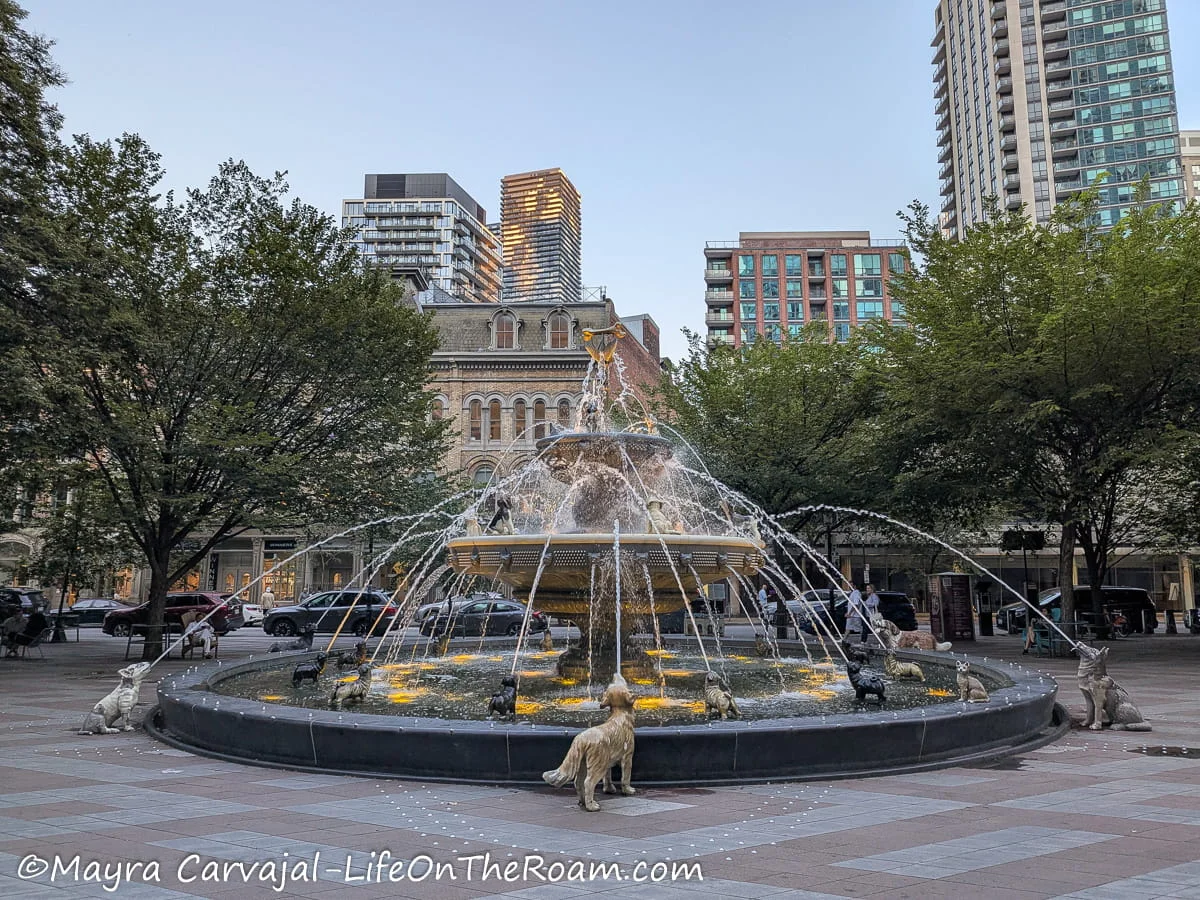 A round 2-tier fountain with sculptures of dogs